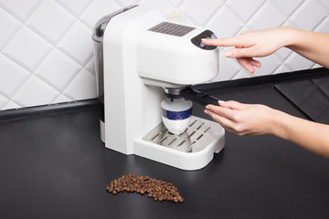 woman make espresso on white espresso coffee machine on kitchen