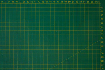green cutting mat scale with scratch texture from cutter