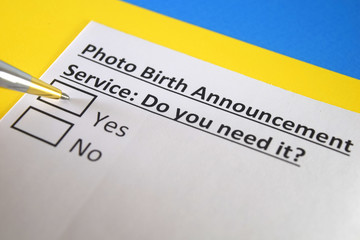 One person is answering question about photo birth announcement service.