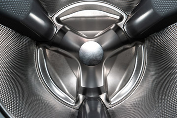 Inside shot of empty silver washing machine drum wide angle view