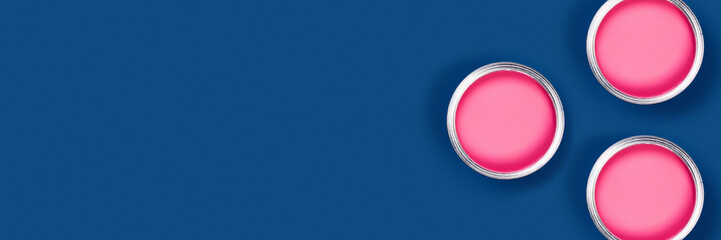 Repair concept. Classic blue background with three paint cans. Flat lay, top view, copy space.