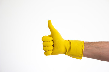Caucasian male hand in yellow latex glove doing the thumbs up sign front view isolated on white
