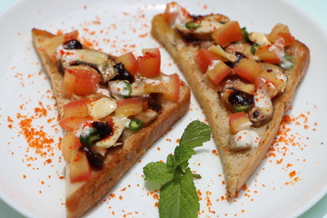 Brushetta or tapas with savory mushroom topping on white plate. Italian antipasti appetizer open toast sandwich