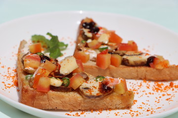 Brushetta or tapas with savory mushroom topping on white plate. Italian antipasti appetizer open toast sandwich