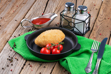chicken Kiev with tomatoes on a plate