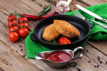 Deep-fried cutlet with vegetables on a plate
