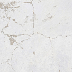 the white wall of an old house with beautiful cracks from time. white paint and whitewash on the wall. the background is white with soft blue and yellow. white old wall background