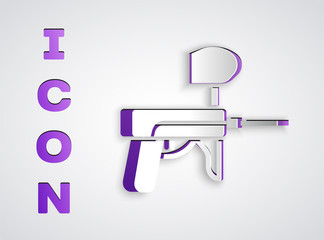 Obraz premium Paper cut Paintball gun icon isolated on grey background. Paper art style. Vector Illustration