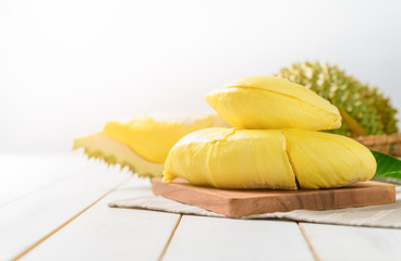 Fresh cut durian (monthong) on wood block and white wood