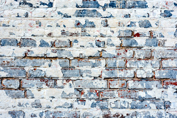 Texture of a brick wall with cracks and scratches which can be used as a background
