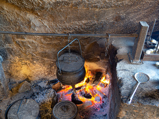 stew cooking on open fire, horizontal