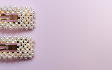 hair pins with pearls on a pink background
