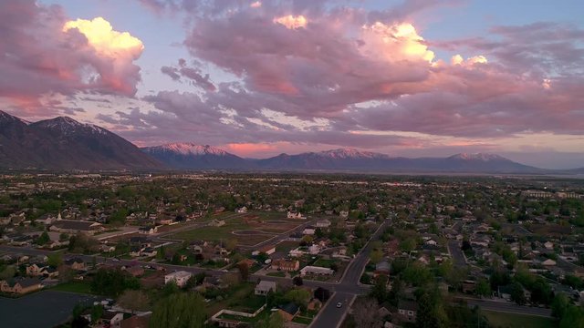 Sunset aerial hyperlapse time lapse flying over town in Utah.