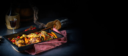 Grilled chicken legs with various vegetables and herbs.