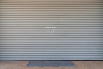steel shutter door background and texture. close shop with show time, business hour 10:00 -20:00