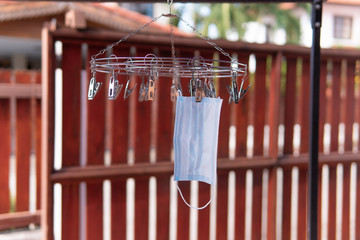Medical mask hanging on clothesline, Cleaned for reuse, Coronavirus and PM 2.5 Makes the mask lack