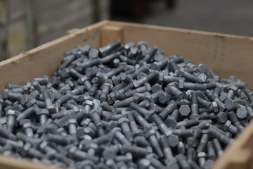 the raw material of the screw and machine producing bolts at the factory 