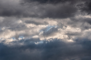 Obraz premium Storm clouds. The sky before a thunderstorm. Rays of the sun through dark thunderclouds
