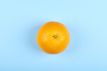 Ripe and fresh orange fruit on blue background.