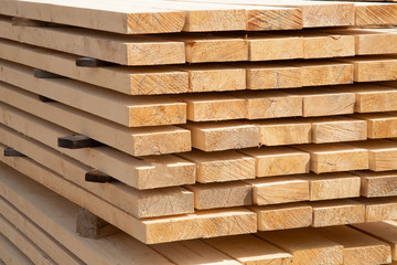 Edged boards in stock, ready for sale. Warehouse of construction materials.