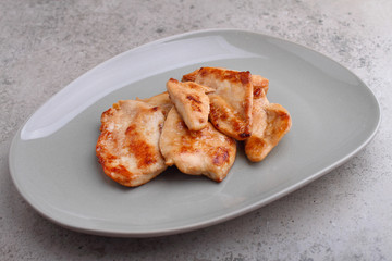 Fried chicken with soy sauce on a plate decorated with sesame seeds