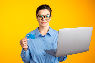 Shopping online. Female holding laptop and choosing things to buy
