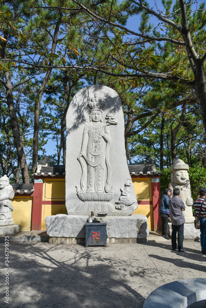 Wall mural Carved stone statues in Guanyin figures at Haedong Yonggung Temple in Busan , South Korea