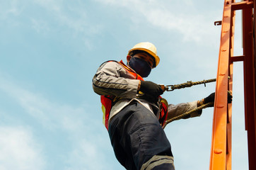 Engineer or Technician wear safety equipment climb high telecom tower for maintenance work, working high risk ,danger job on high level area