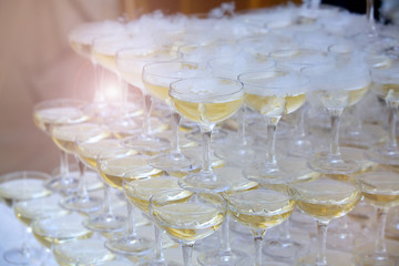 Crystal glasses for holiday, a lot of glasses for guests. Slide pyramid of glasses.