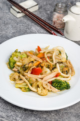 Seafood with vegetables served in a white plate