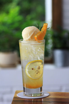 Full glass of water with lemon and icream