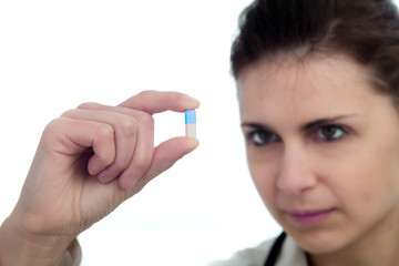 Female doctor holding a pill