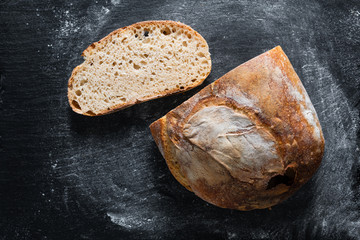 Dark mood and tone Home Cooking Homemade Organic rustic Sourdough bread on black background with...