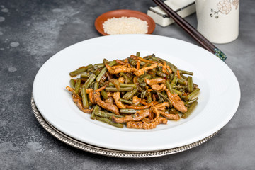 Roasted fern salad with meat in a white plate