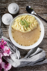 Pure white borscht served with mashed potatoes.