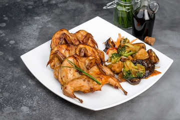 Fried quail in a batter in a white square plate