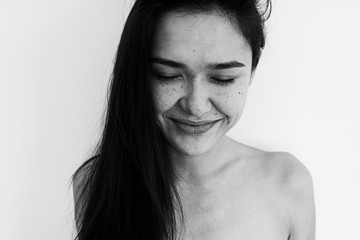black and white portrait of a girl with wrinkles, freckles and moles without retouching