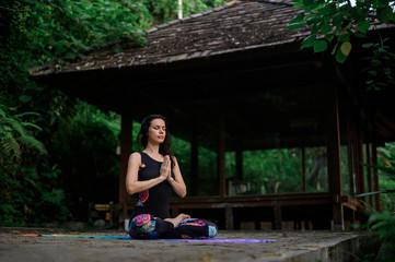 Yoga practice and meditation in nature. Woman practicing near river