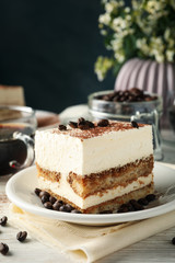 Composition with tasty tiramisu on white wooden background. Delicious dessert