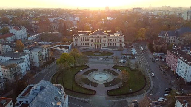 Drone shot flying over the Gesellschaftshaus Zoo Frankfurt in Germany during sunrise