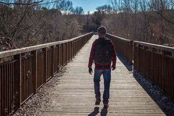 man walking on bridge