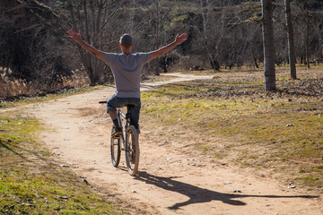 young man riding a bicycle in the park