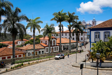 View to traditional houses and palm tree lined street in historic center of Diamantina on a sunny day, Minas Gerais, Brazil
