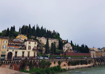 Sights of Verona, old buildings on a hill by the river