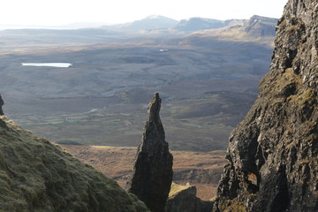 A cylindrical mountain with a highland backdrop.  