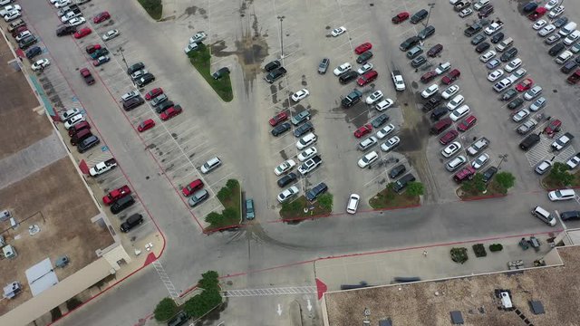 Moving flight over cars and people in a grocery store parking lot, Bryan, Texas, USA