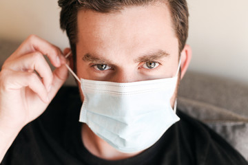 Close up portrait of a young man in medical mask 