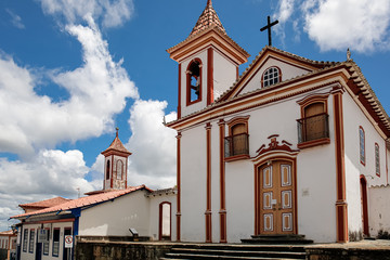 Fototapeta na wymiar View to historic church in white and red, with blue sky and white clouds, Diamantina, Minas Gerais, Brazil 