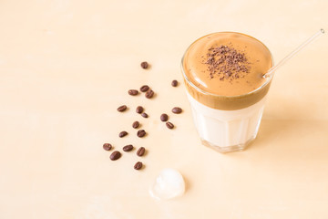Dalgon coffee in a transparent glass on a wooden background