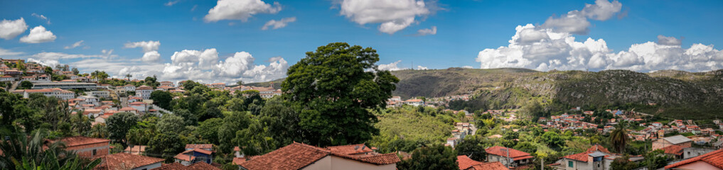 Panoramic view to historic town and mountains with blue sky, white clouds, trees, Diamantina, Minas Gerais, Brazil
